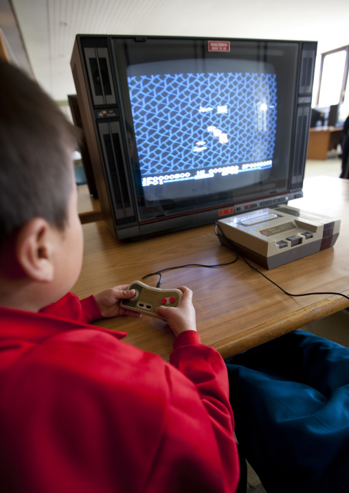 North Korean child playing video games in Songdowon international children's camp, Kangwon Province, Wonsan, North Korea