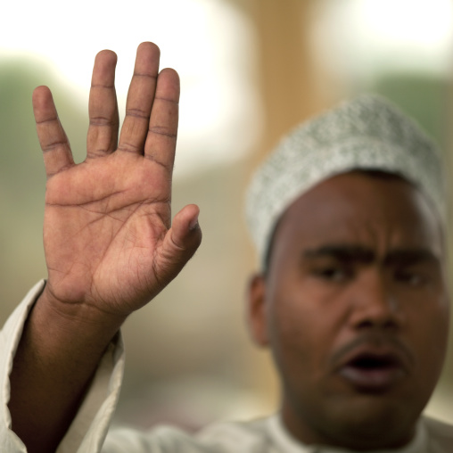 Man Waving Hand In Nizwa Cattle Market, Nizwa, Oman