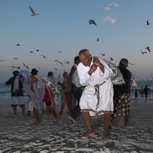 Men Taking Fishes Back Home At Dusk, Salalah, Oman