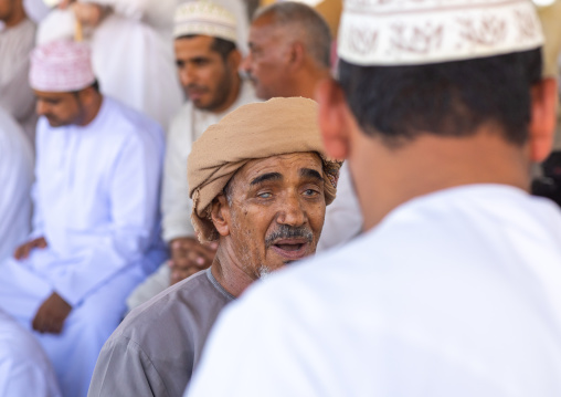 Omani men in the cattle market, Ad Dakhiliyah Region, Nizwa, Oman