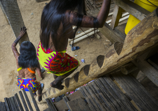 Panama, Darien Province, Bajo Chiquito, Embera Tribe Women Climbing A Ladder In A House