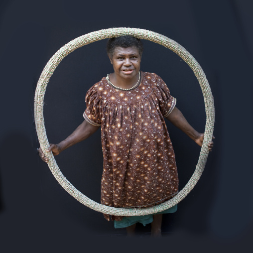 Woman holding a giant shell money, East New Britain Province, Rabaul, Papua New Guinea