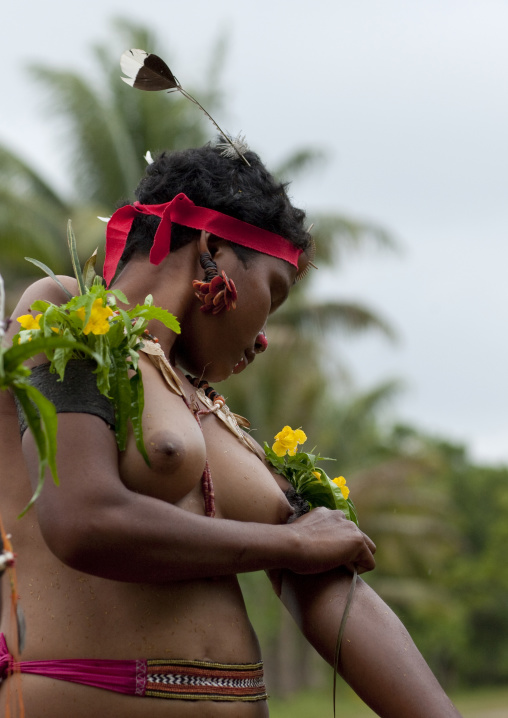 Portrait of a topless tribal woman in traditional clothing, Milne Bay Province, Trobriand Island, Papua New Guinea