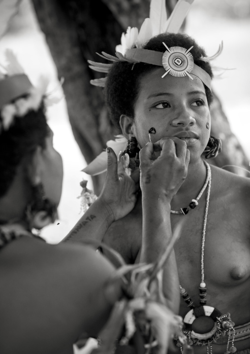 Tribal woman makeup before a ceremony, Milne Bay Province, Trobriand Island, Papua New Guinea