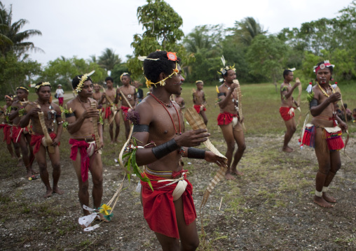 Tribal dancers in traditional clothing during a sing-sing, Milne Bay Province, Trobriand Island, Papua New Guinea