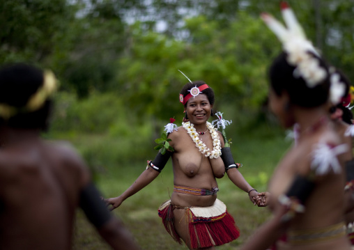 Tribal topless women dancing during a sing-sing, Milne Bay Province, Trobriand Island, Papua New Guinea