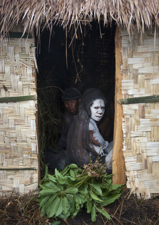 Portrait of a mourning woman in a hut with job tears necklaces, Western Highlands Province, Mount Hagen, Papua New Guinea