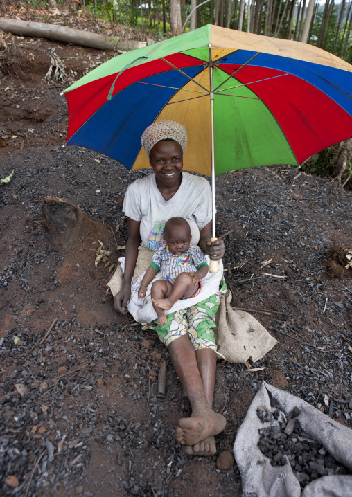 Rwandan woman selling coal, Western Province, Cyamudongo, Rwanda