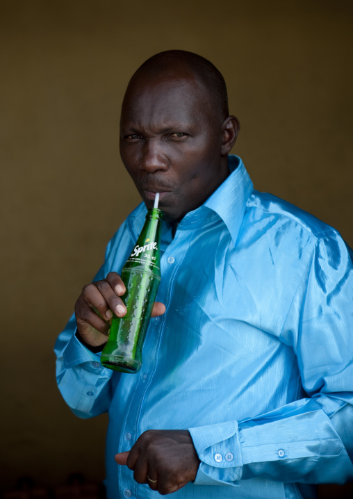 Rwandan man drinking a sprite drink with a straw, Kigali Province, Kigali, Rwanda