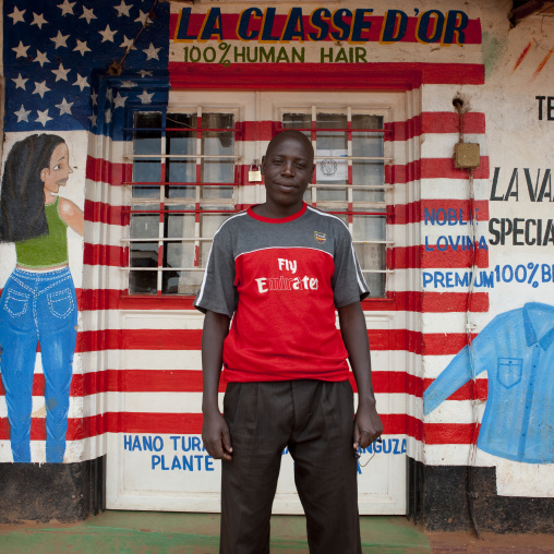 Rwandan man in front of a tailor shop mural, Kigali Province, Kigali, Rwanda