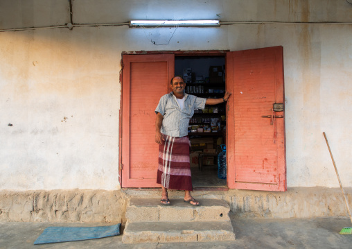 Saudi man standing at the entrance of his shop, Jizan province, Alaydabi, Saudi Arabia