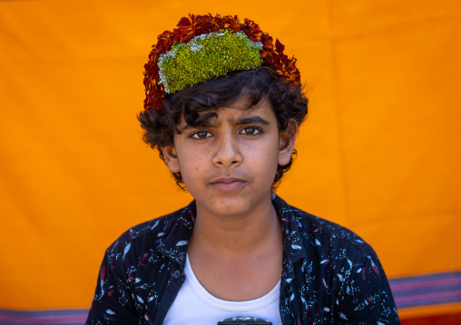 Portrait of a flower boy wearing a floral crown on the head, Jizan province, Addayer, Saudi Arabia