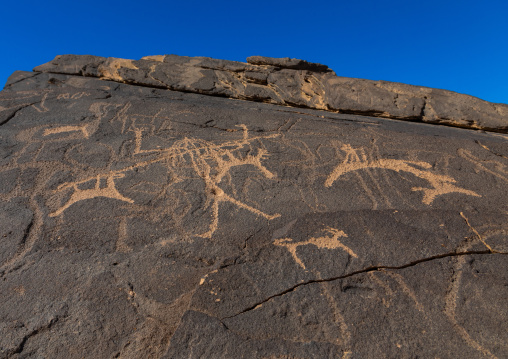 Petroglyphs on a rock depicting hunters, Najran Province, Thar, Saudi Arabia