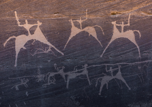 Petroglyphs on a rock depicting men hunting on horses, Najran Province, Minshaf, Saudi Arabia