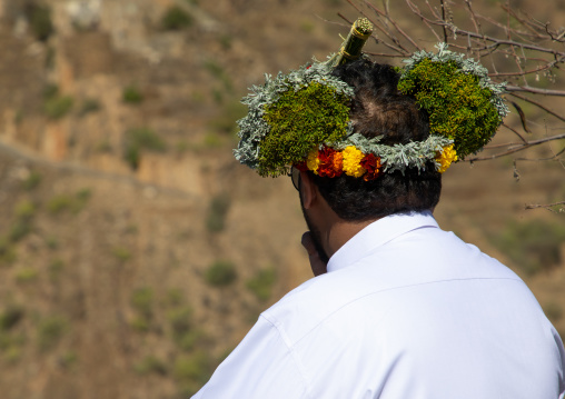 Rear view of a flower man wearing a floral crown on the head, Jizan Province, Addayer, Saudi Arabia