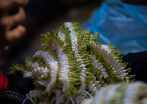 Vendor preparing a floral crown in a market, Jizan Province, Sabya, Saudi Arabia