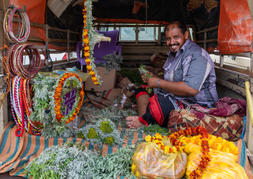 A flower vendor preparing floral garlands and crowns on a market, Jizan Province, Addayer, Saudi Arabia