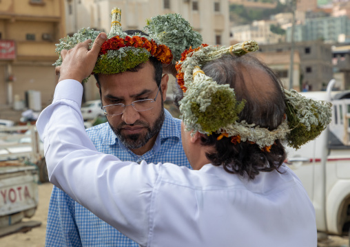 Portrait of a flower man offering a floral crown to a friend, Jizan Province, Addayer, Saudi Arabia