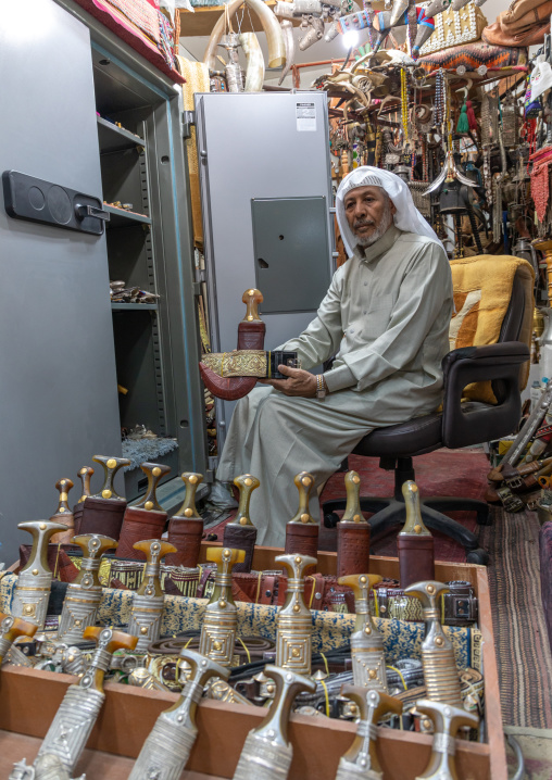 Saudi man holding a janbiya dagger kept in a safe, Najran Province, Najran, Saudi Arabia