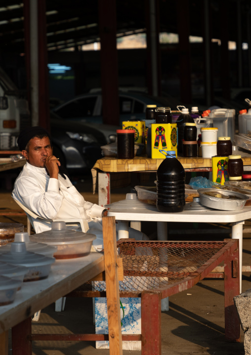 Saudi man selling honey and honeycombs on a market, Asir province, Al Habeel, Saudi Arabia