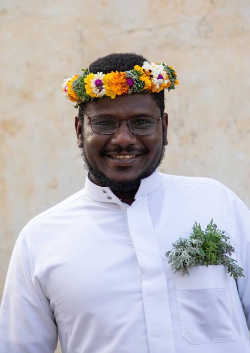 Portrait of a flower man wearing a floral crown on the head, Asir province, Muhayil, Saudi Arabia