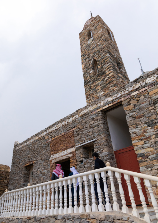 Saudi men entering a mosque made of stones, Asir province, Tanomah, Saudi Arabia