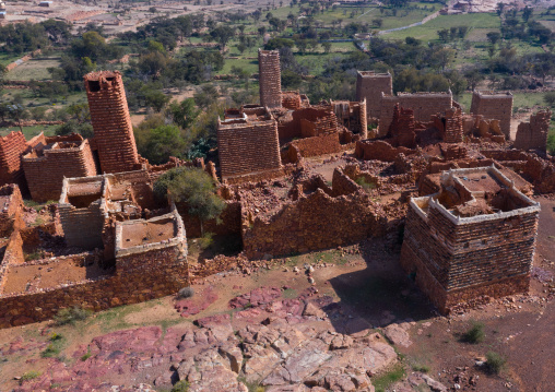 Aerial view of red stone and mud houses with slates in a village, Asir province, Sarat Abidah, Saudi Arabia