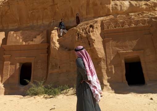 Saudi tourist in front of a Nabataean tomb in al-Hijr archaeological site in Madain Saleh, Al Madinah Province, Alula, Saudi Arabia