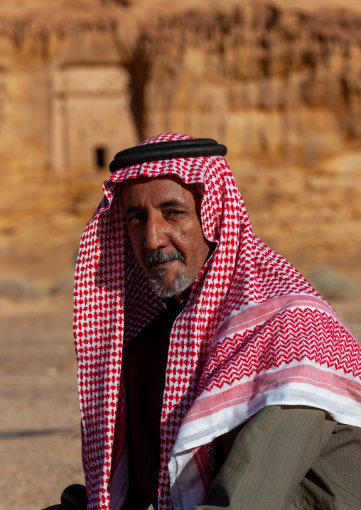 Saudi tourist visiting a nabataean tomb in madain saleh archaeologic site, Al Madinah Province, Al-Ula, Saudi Arabia