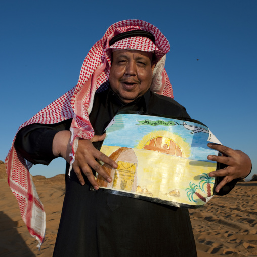Saudi teatcher showing the drawings of his pupils, Al Madinah Province, Alula, Saudi Arabia