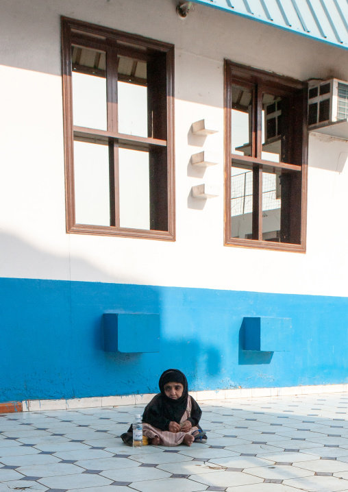 Handicapped woman begging for money near a mosque, Hijaz Tihamah region, Jeddah, Saudi Arabia