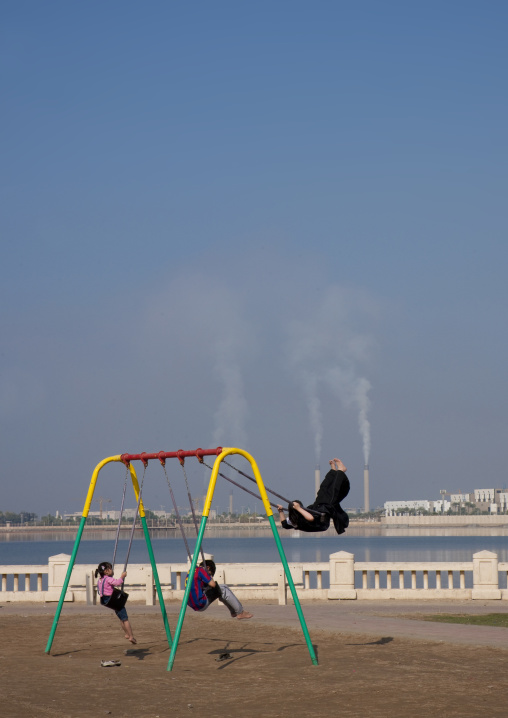 Saudi children on a swing, Mecca province, Jeddah, Saudi Arabia