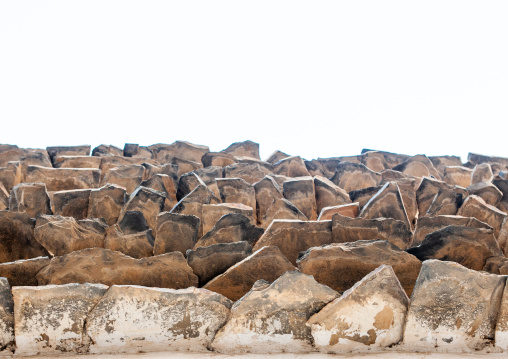 Low angle view of an old traditional building with stones protecting adobe from the rain, Asir province, Abha, Saudi Arabia