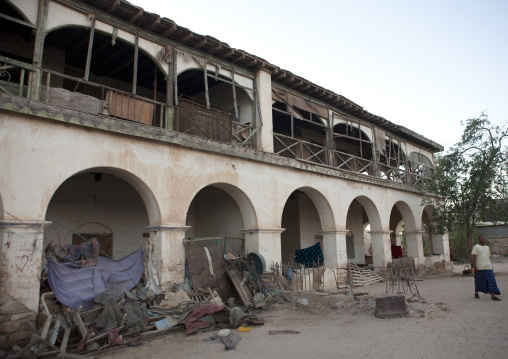 A Man Walking Outside A Former Ottoman Empire House With Waste, Berbera Area, Somaliland