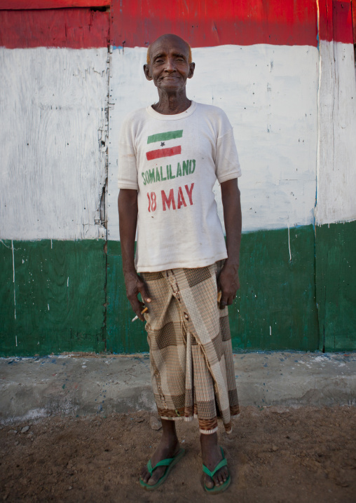 Senior Man Wearing A Somaliland Tshirt In Front Of A Painted Wall, Zeila, Somaliland