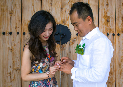 North korean defector joseph park putting wedding ring on the finger of his south korean fiancee juyeon, Sudogwon, Paju, South korea