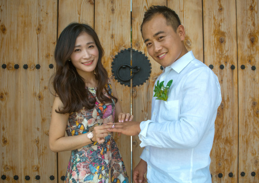 North korean defector joseph park putting wedding ring on the finger of his south korean fiancee juyeon, Sudogwon, Paju, South korea
