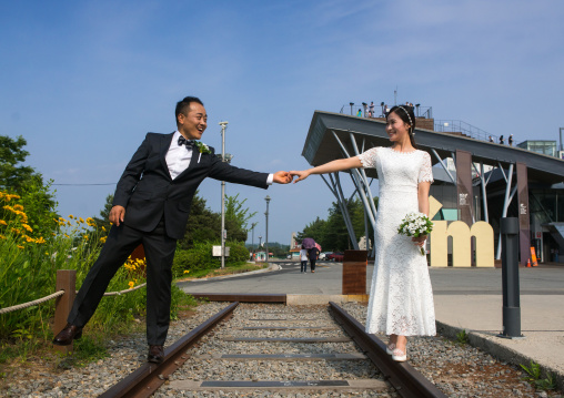 North korean defector joseph park taking a picture of his south korean fiancee juyeon on the north and south korea border, Sudogwon, Paju, South korea