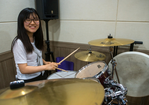 North korean teen defector in yeo-mung alternative school playing drums, National capital area, Seoul, South korea