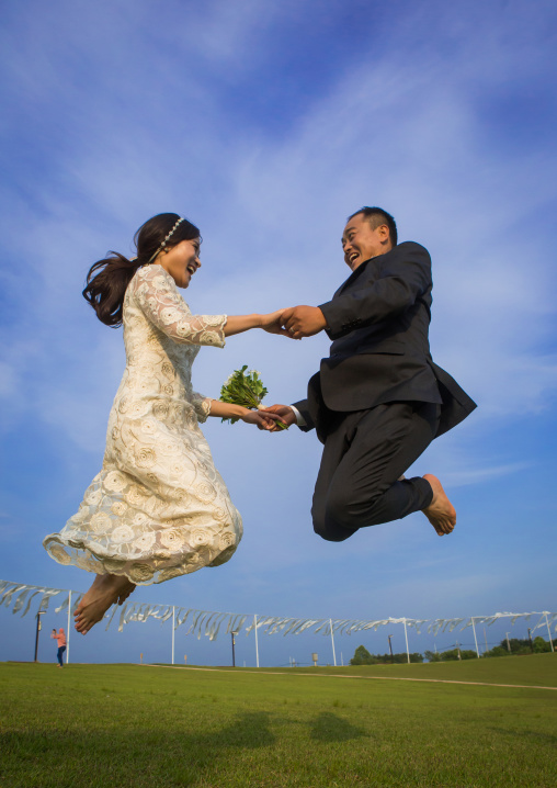 North korean defector joseph park with his south korean fiancee called juyeon jumping in imjingak park, Sudogwon, Paju, South korea
