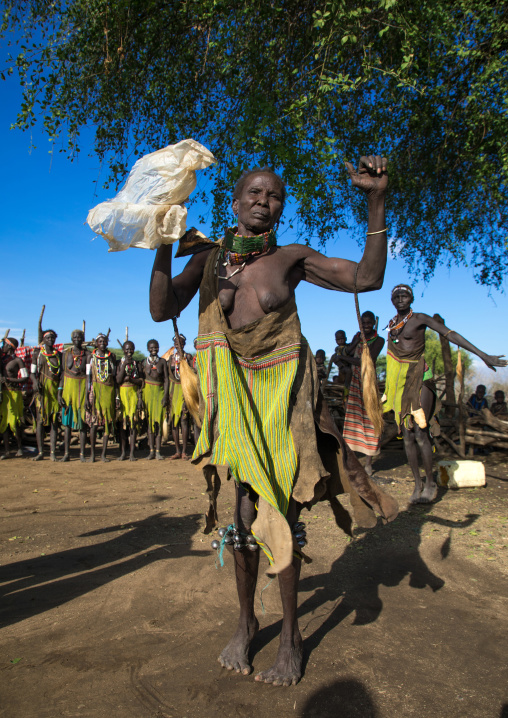 Toposa tribe woman in traditional clothing dancing during a ceremony, Namorunyang State, Kapoeta, South Sudan