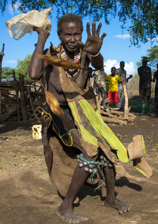 Toposa tribe woman in traditional clothing dancing during a ceremony, Namorunyang State, Kapoeta, South Sudan
