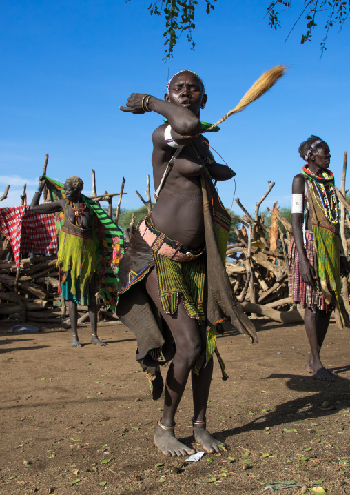 Toposa tribe woman in traditional clothing dancing during a ceremony, Namorunyang State, Kapoeta, South Sudan