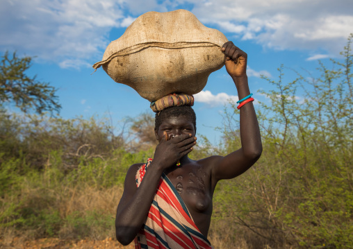 Larim tribe woman carrying a bag on her head, Boya Mountains, Imatong, South Sudan