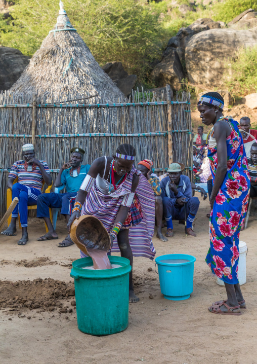 Larim tribe woman carrying alcohol during a wedding ceremony, Boya Mountains, Imatong, South Sudan