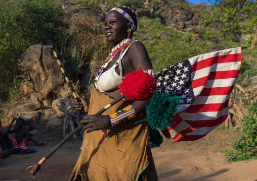 Larim tribe woman with an american flag during a wedding celebration, Boya Mountains, Imatong, South Sudan