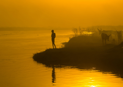 Mundari tribe child on the bank of river Nile at sunset, Central Equatoria, Terekeka, South Sudan
