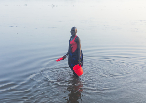 Mundari tribe woman collecting water in the river Nile, Central Equatoria, Terekeka, South Sudan