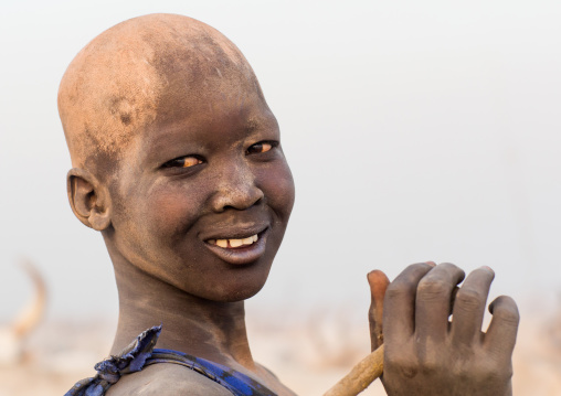 Smiling Mundari tribe boy covered in ash to repel flies and mosquitoes in a cattle camp, Central Equatoria, Terekeka, South Sudan