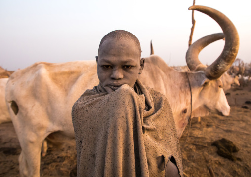 A Mundari tribe boy wrapped in blanket to fight the cold in a cattle camp, Central Equatoria, Terekeka, South Sudan